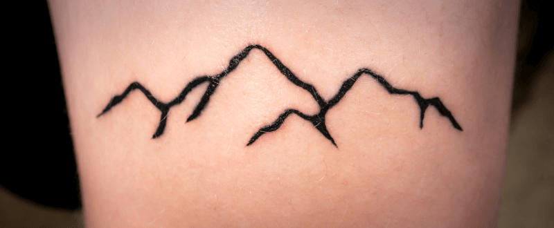Minimalist mountain tattoo design
