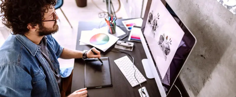 tattoo artist designing in a laptop