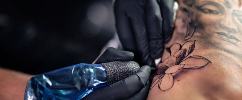 tattoo artist doing daffodil tattoo