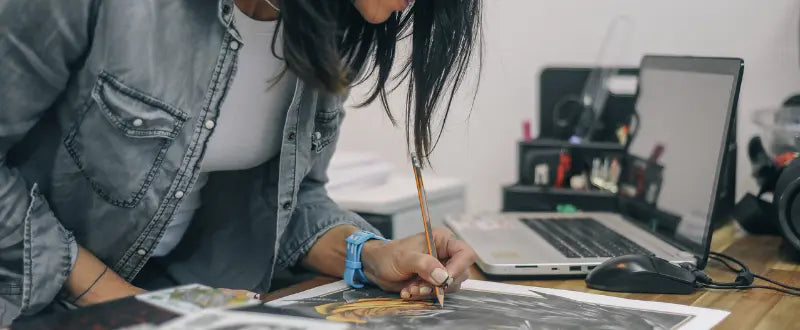 tattoo artist drawing her tattoo design