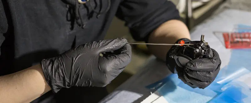 tattoo artist holding a tattoo machine