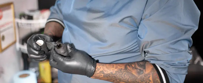 tattoo artist holding his tattoo machine