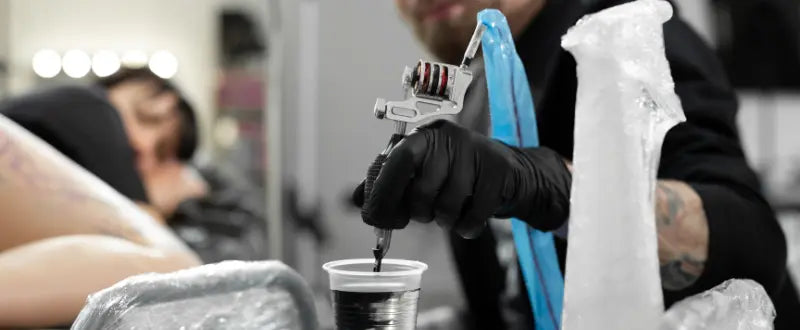 tattoo artist preparing his tattoo inks