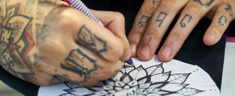 tattoo artist sketching a design