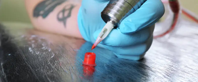 tattoo machine and red tattoo ink