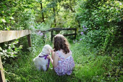 Girl with dog in a garden