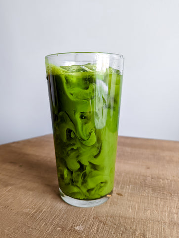 Iced matcha in a glass swirled