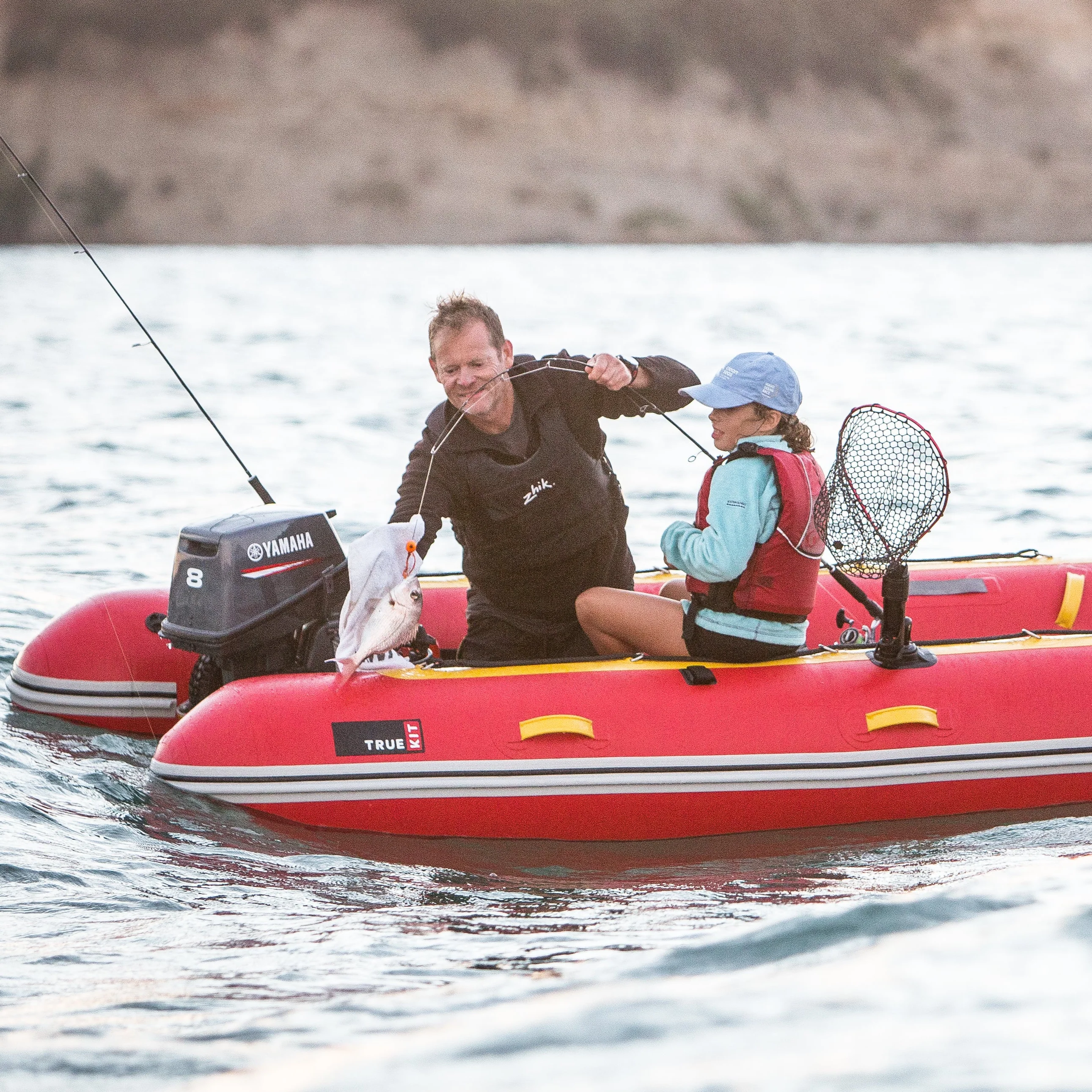 A man and his daughter fishing using Truekit inflatable boat
