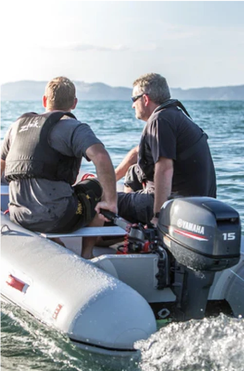 2 guys riding an inflatable boat