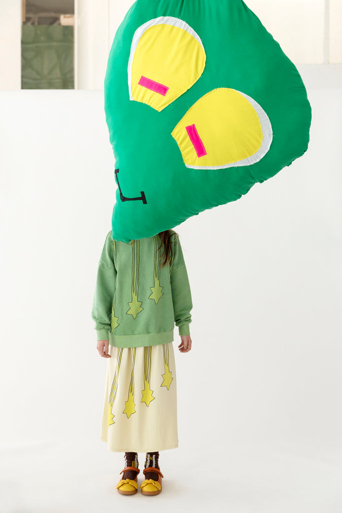 Young girl in Fresh Dinosaurs Stars Sweatshirt and Stars Skirt at Design Life Kids.