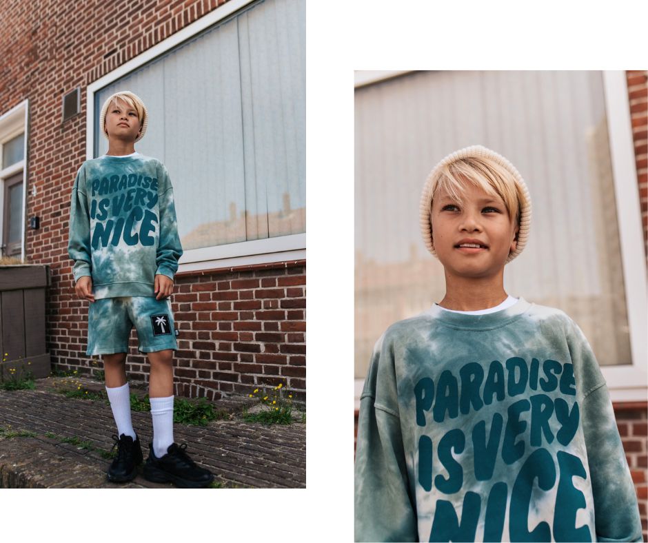 Young boy in Little Man Happy Paradise Is Very Nice Tie Dye Sweatshirt and Paradise Palms Tie Dye Board Shorts at Design Life Kids