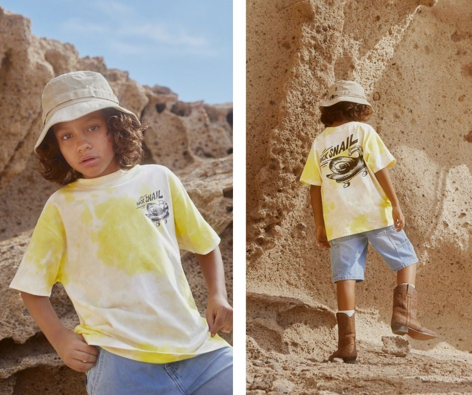 Young boy in Molo Rodney Lemon Sand T-Shirt at Design Life Kids