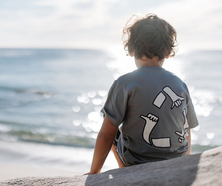 Young boy staring out into the ocean in Munsterkids Royal Tee at Design Life Kids