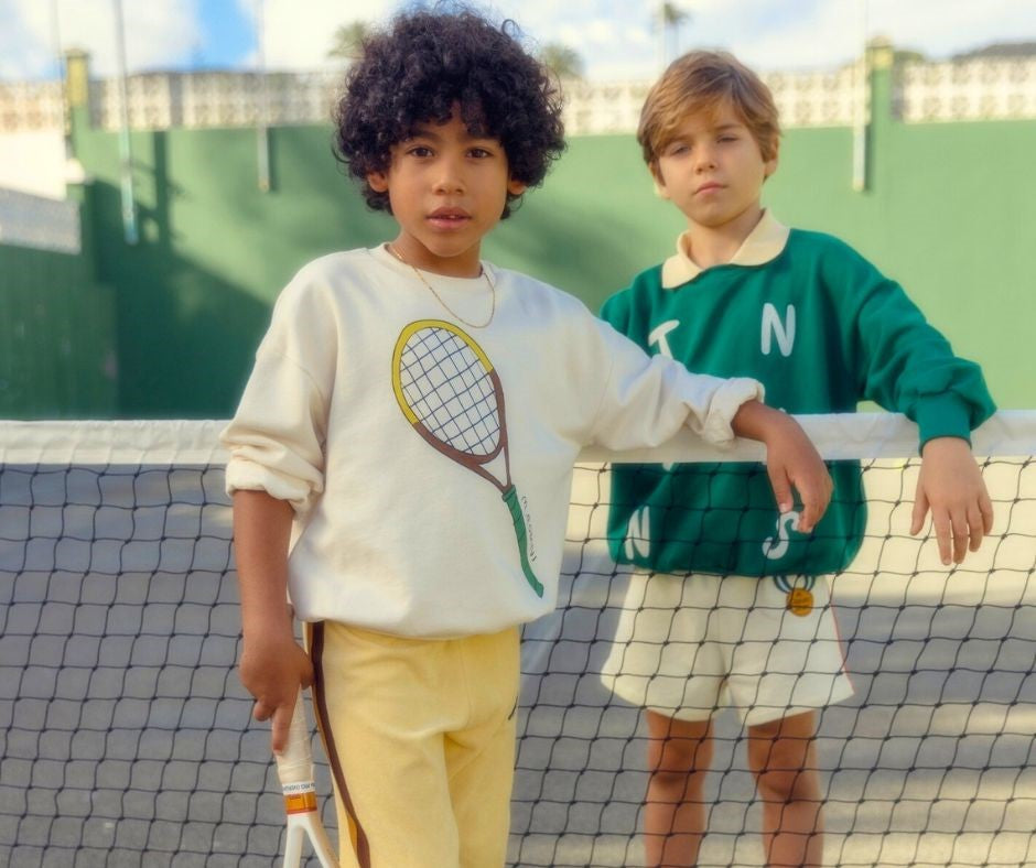 Young boys in Mini Rodini Tennis Sweatshirt and Tennis Collared Sweatshirt at Design Life Kids