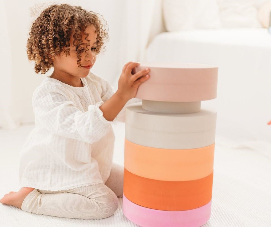 Young girl playing with Moes Rainbow Chair (Earth) at Design Life Kids