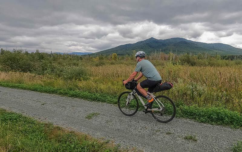 Tim Peck riding loaded Journeyer bike on gravel trail