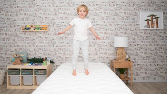 kid jumping on mattress