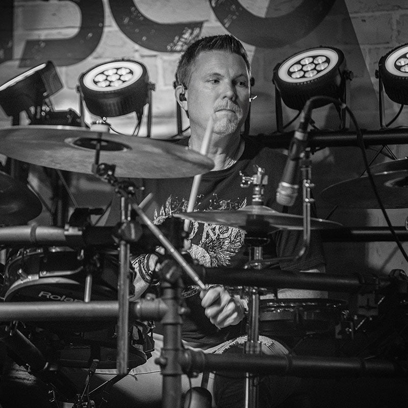 Garrett Aurre Scorpion Percussion Signature Artist poses with drumsticks