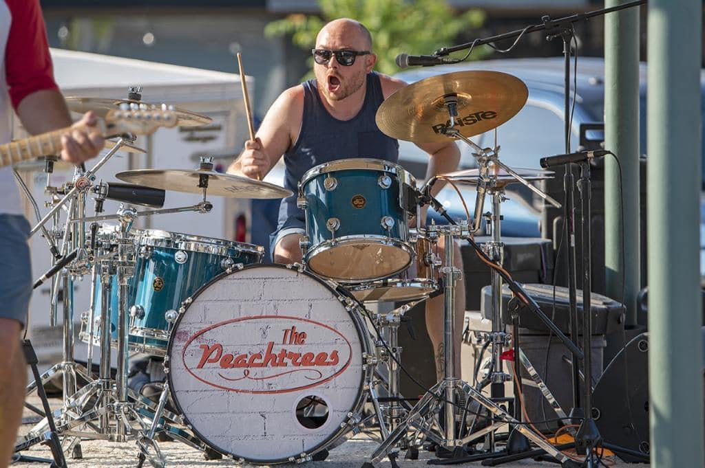 Drummer Justin Blasier poses with Scorpion Percussion drumsticks behind his drumkit