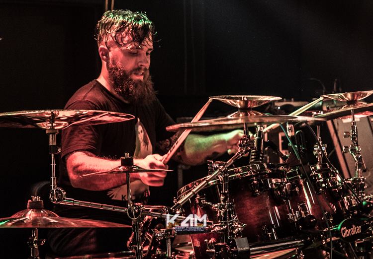 Drummer Kenny Shillingburg poses with Scorpion Percussion drumsticks behind his drumkit