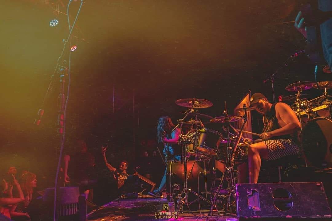 Drummer Josh Musick poses with Scorpion Percussion drumsticks behind his drumkit