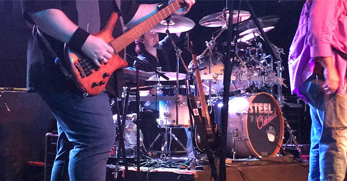 Drummer Jeff Dare poses with Scorpion Percussion drumsticks behind his drumkit