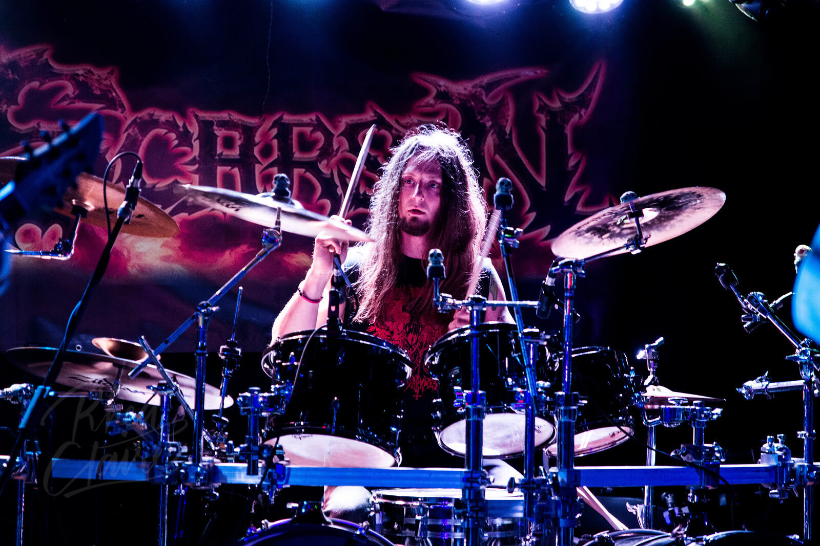 Drummer Jason Caruana poses with Scorpion Percussion drumsticks behind his drumkit