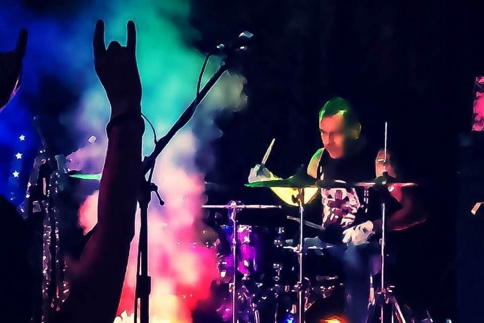 Drummer Mike Dillon poses with Scorpion Percussion drumsticks behind his drumkit