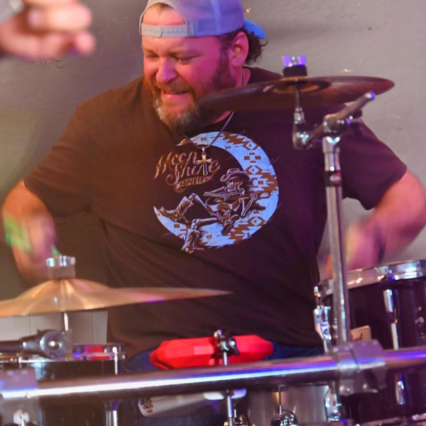 Drummer Scott Wynn poses with Scorpion Percussion drumsticks behind his drumkit