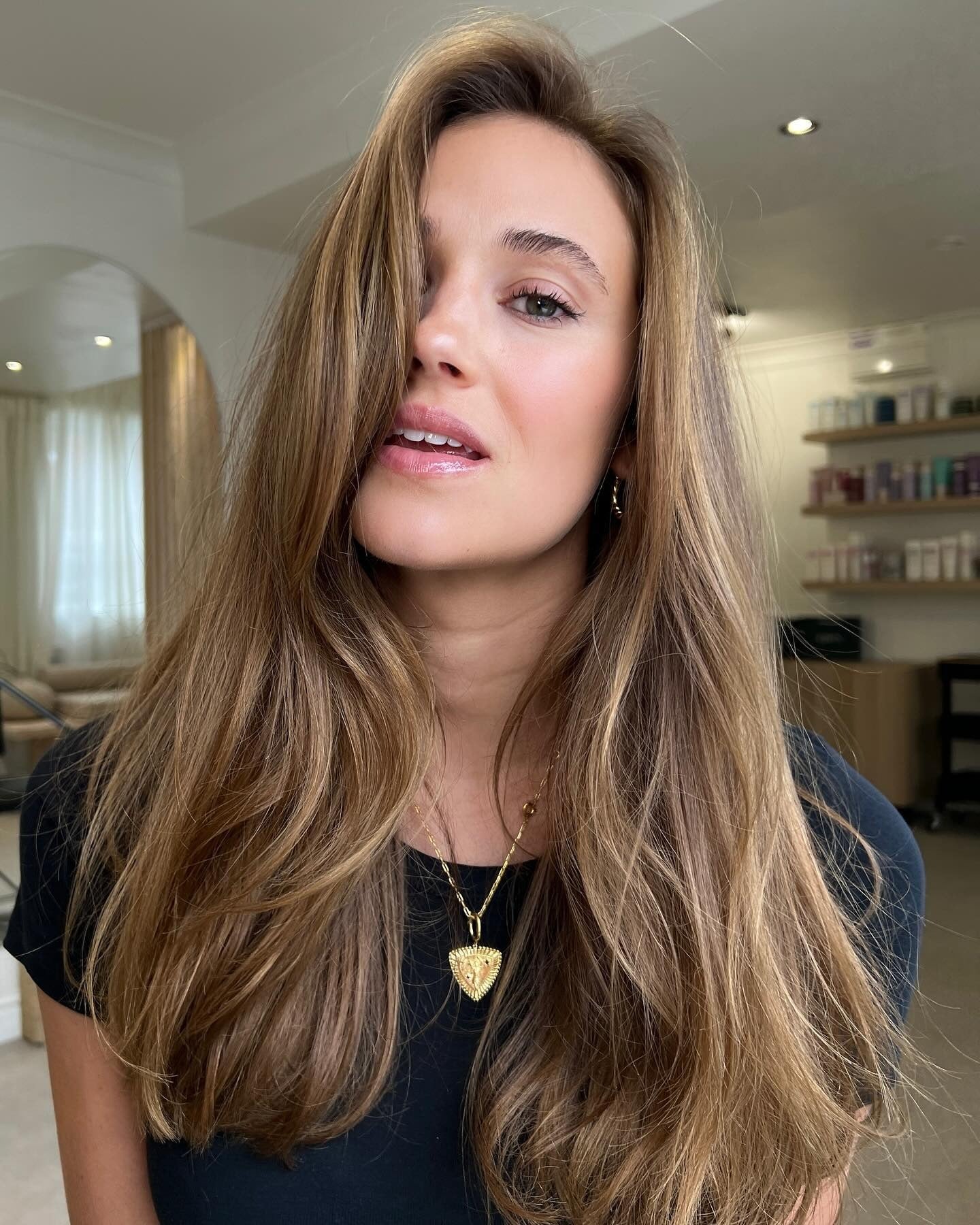 10. Rich Golden Layers with Smooth Curtain Bangs - Golden Brown Hair Color