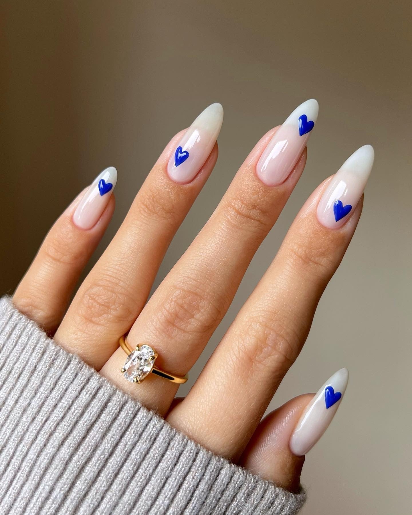 14. Royal Blue Hearts on Glossy Almond Ombre - Heart Nail Ideas