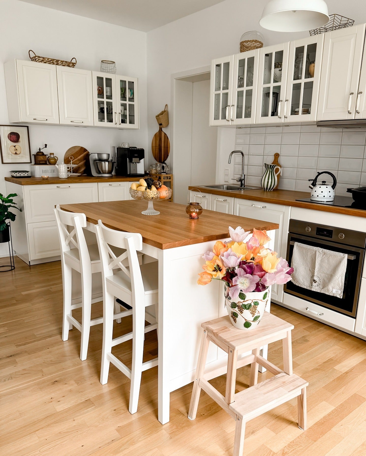 7. Classic White with Glass Elegance - Cozy Kitchen Ideas