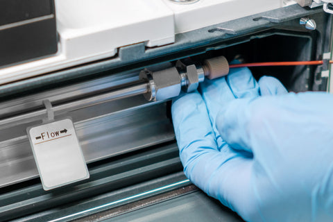 lab assistant inserting pepper sample through the HPLC column