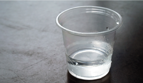 a close-up shot of a glass of tap water sitting on a counter