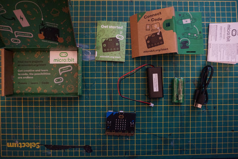 micro:bit box open on a cutting mat, all the contents are spread across the mat 