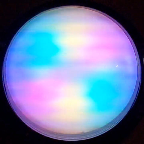 round button against a black background - top is showing pastel multicolour diffused lights