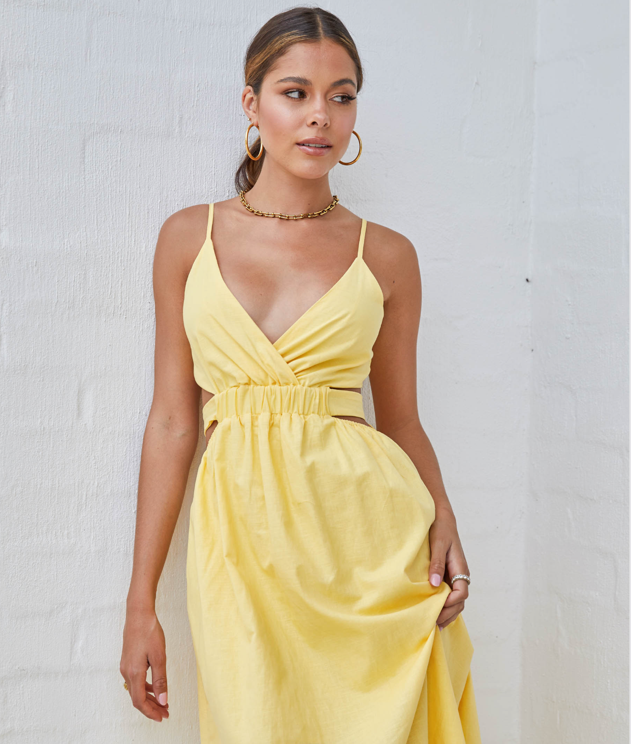 Yellow midi dress with cutouts.