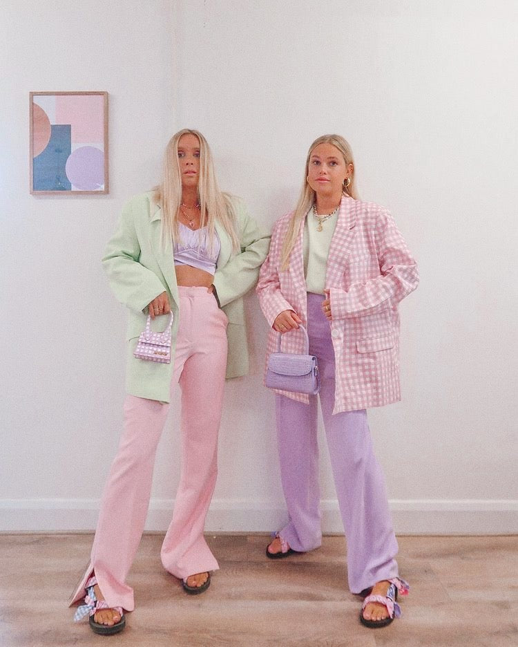 Two girls in pastel coloured outfits