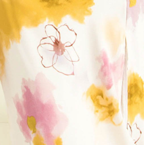 White midi dress with a pink and yellow floral print.
