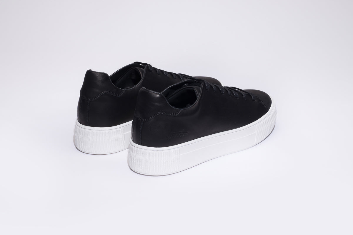 black sports shoes with white sole