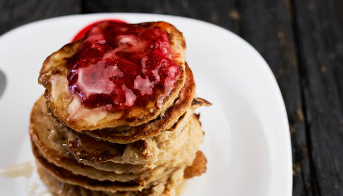 A stack of keto breakfast pancakes topped with sugar-free strawberry jam
