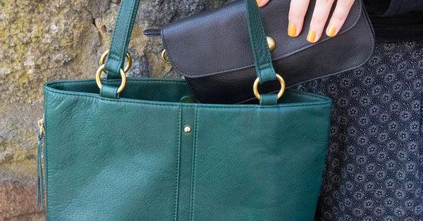 woman placing wallet into tote bag