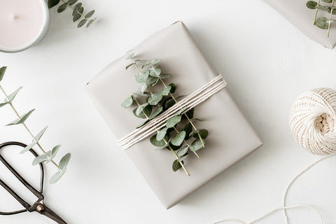 present wrapped with greenery