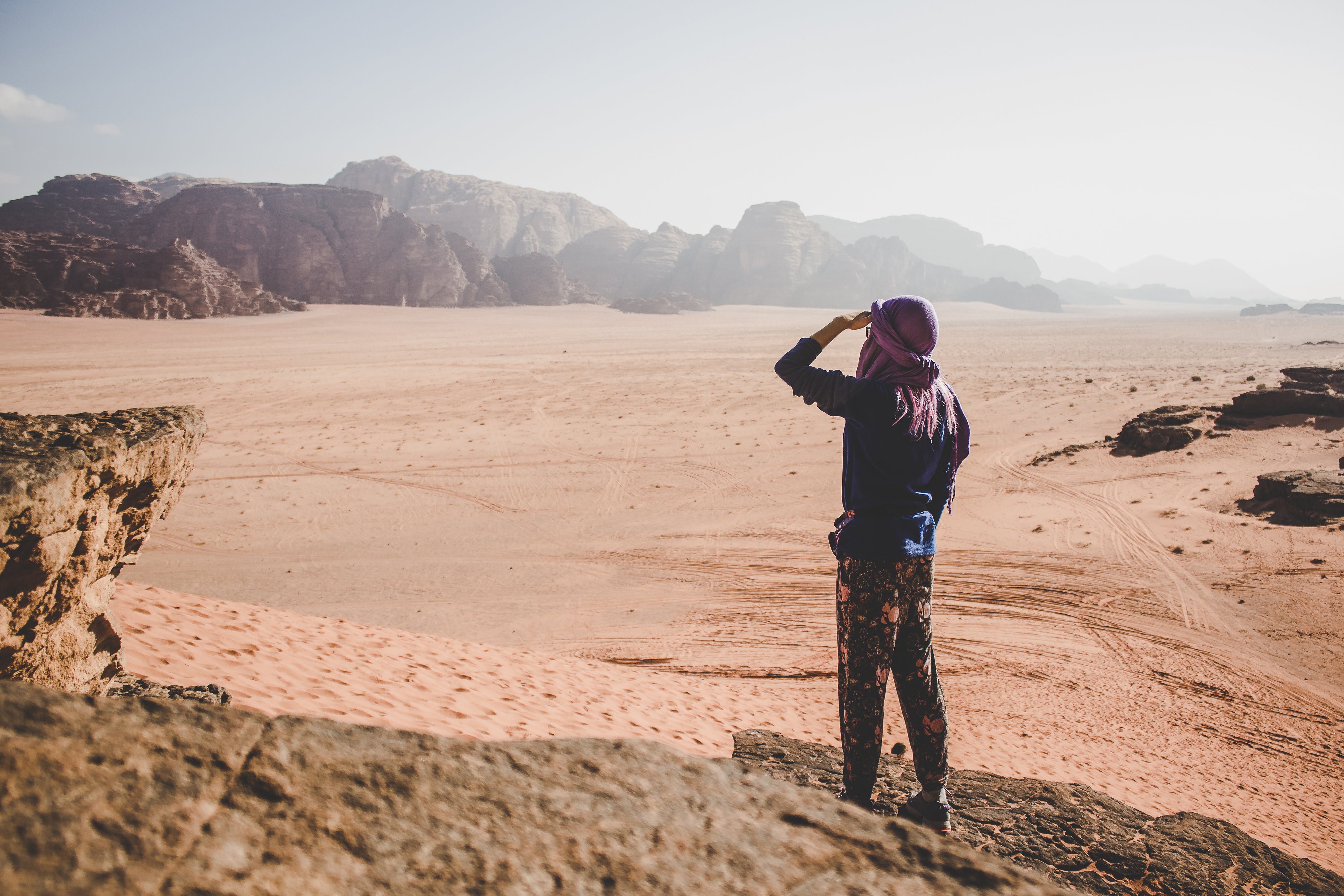 man looking at desert plains