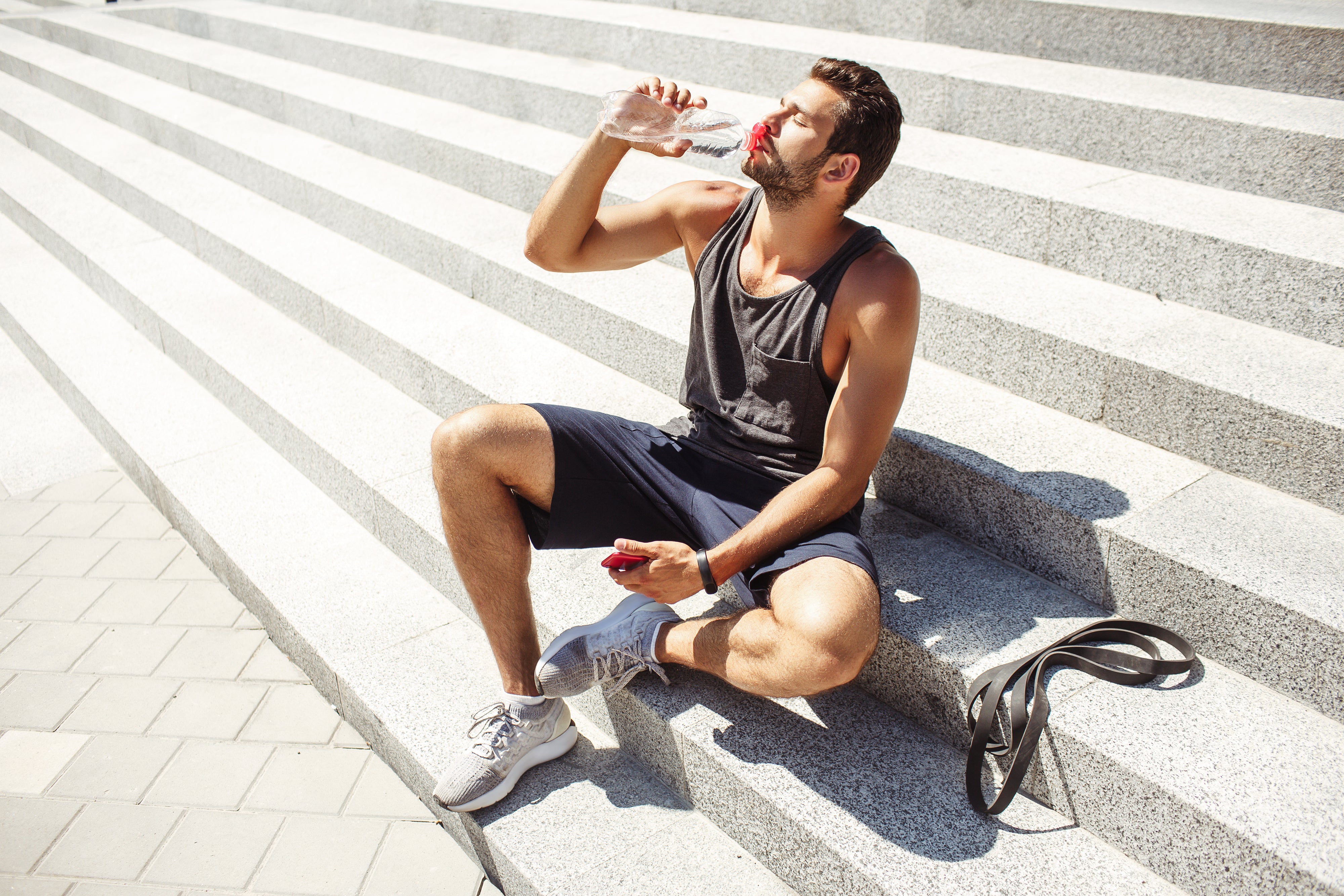 man drinking water on steps