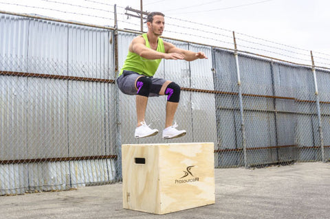 Man jumping onto a plyometric jump box