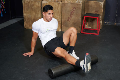 Man stretching legs after a workout with the ProsourceFit High Density Foam Roller