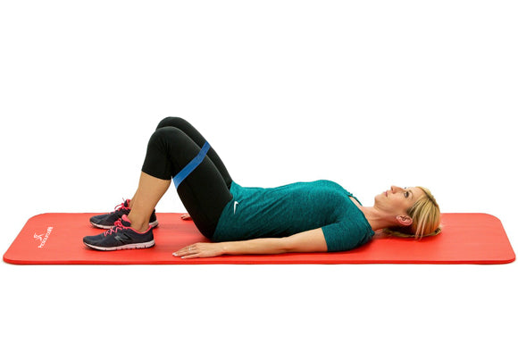 woman lying on prosourcefit extra thick yoga and pilates mat with loop resistance bands in starting position for bridge