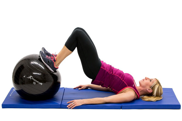 woman performing hamstring curl on prosourcefit stability ball