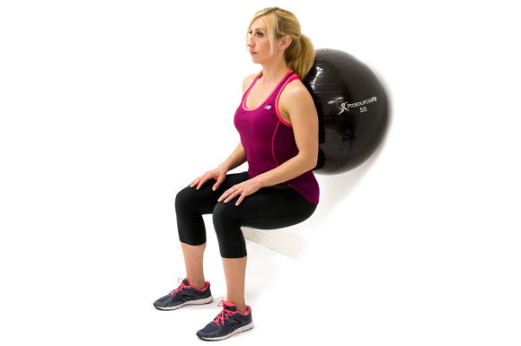 woman leaning on prosourcefit stability ball in standing squat